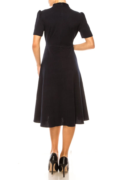 Maggy London black short-sleeved midi dress with mock neck and flared skirt