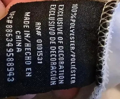 Black fabric clothing label with white text on Marvel Deadpool Deadpool graphic hoodie