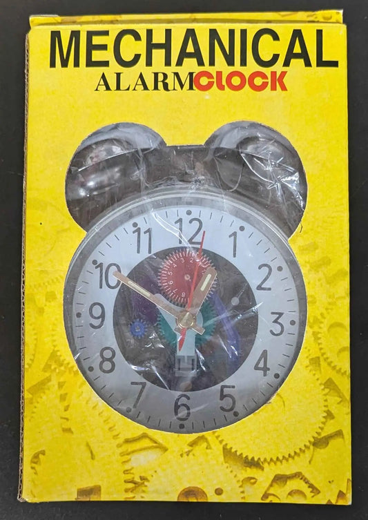 Mechanical alarm clock packaging in yellow box featuring twin-bell clock face