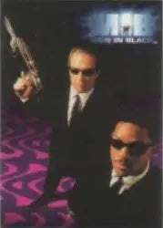 Two men in black suits and sunglasses on Men In Black promo card from 1997