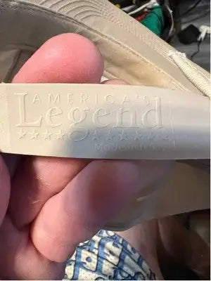 Beige strap with embossed text on America’s Legend Men’s Reward Hat for a stylish look