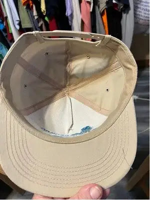 Light-tan America’s Legend men’s baseball cap with adjustable plastic strap