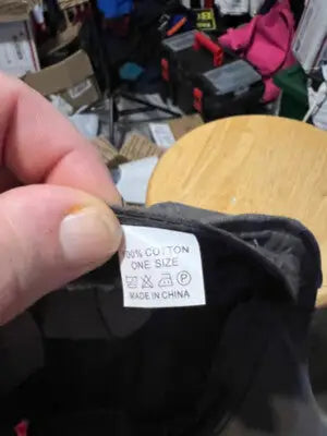 Black garment care label on Men’s Gray Stylish Flat Cap showing care instructions