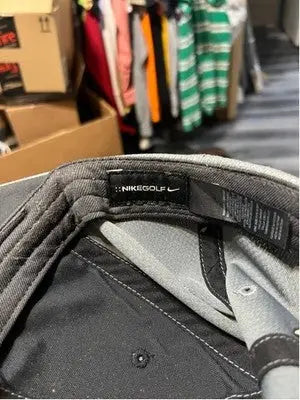 Black Nike Golf fitted hat with gray inner lining and Nike Swoosh logo