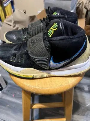 Black Nike Kyrie basketball sneakers with neon green accents, men’s athletic shoes