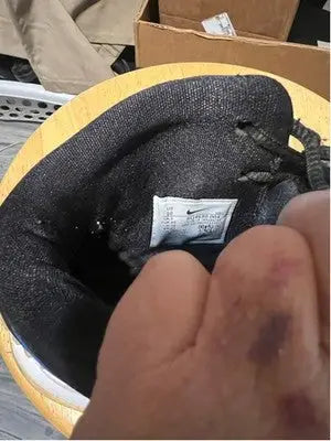 Interior view of black Nike Kyrie athletic shoes with white brand label for Men’s Nike Kyrie 6