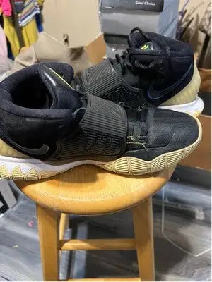 Black Nike Kyrie athletic shoes with straps and tan soles for men size 10