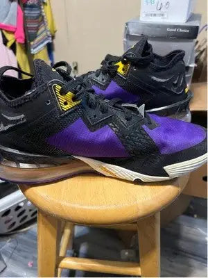Nike LeBron athletic shoes in black and purple with yellow accents for men