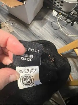 Black knitted Beanie with NHL logo tag featuring Philadelphia Flyers and white stripe design