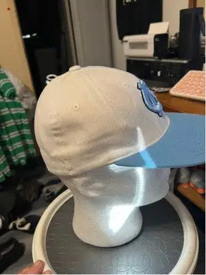 Light-colored men’s Zephyr UNC Tar Heels hat with light blue brim and emblem