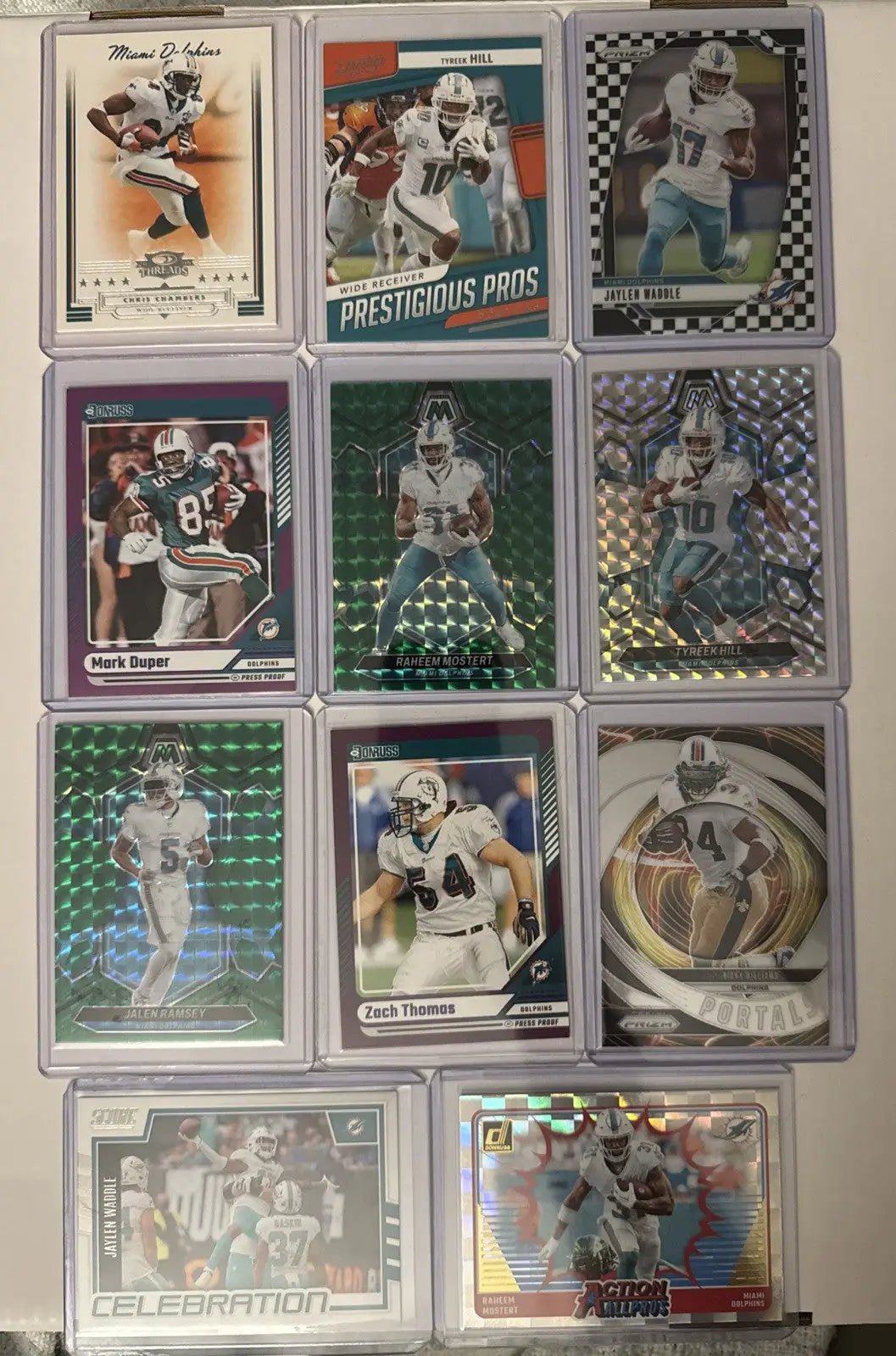 Miami Dolphins card lot featuring twelve football trading cards in protective sleeves