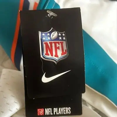 Black NFL hang tag with NFL shield logo Nike swoosh and NFL Players logo for Miami Dolphins jersey