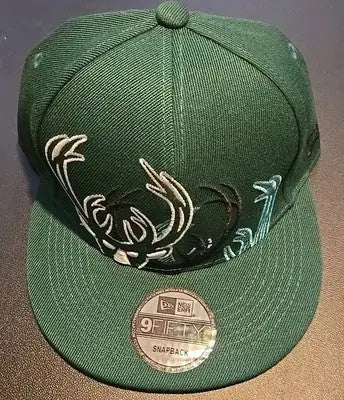 Dark green Milwaukee Bucks hat with embroidered deer antler design and SGc graded Giannis card