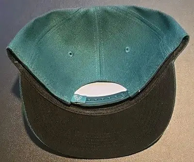 Dark teal Milwaukee Bucks hat with black brim and adjustable snapback, perfect for fans