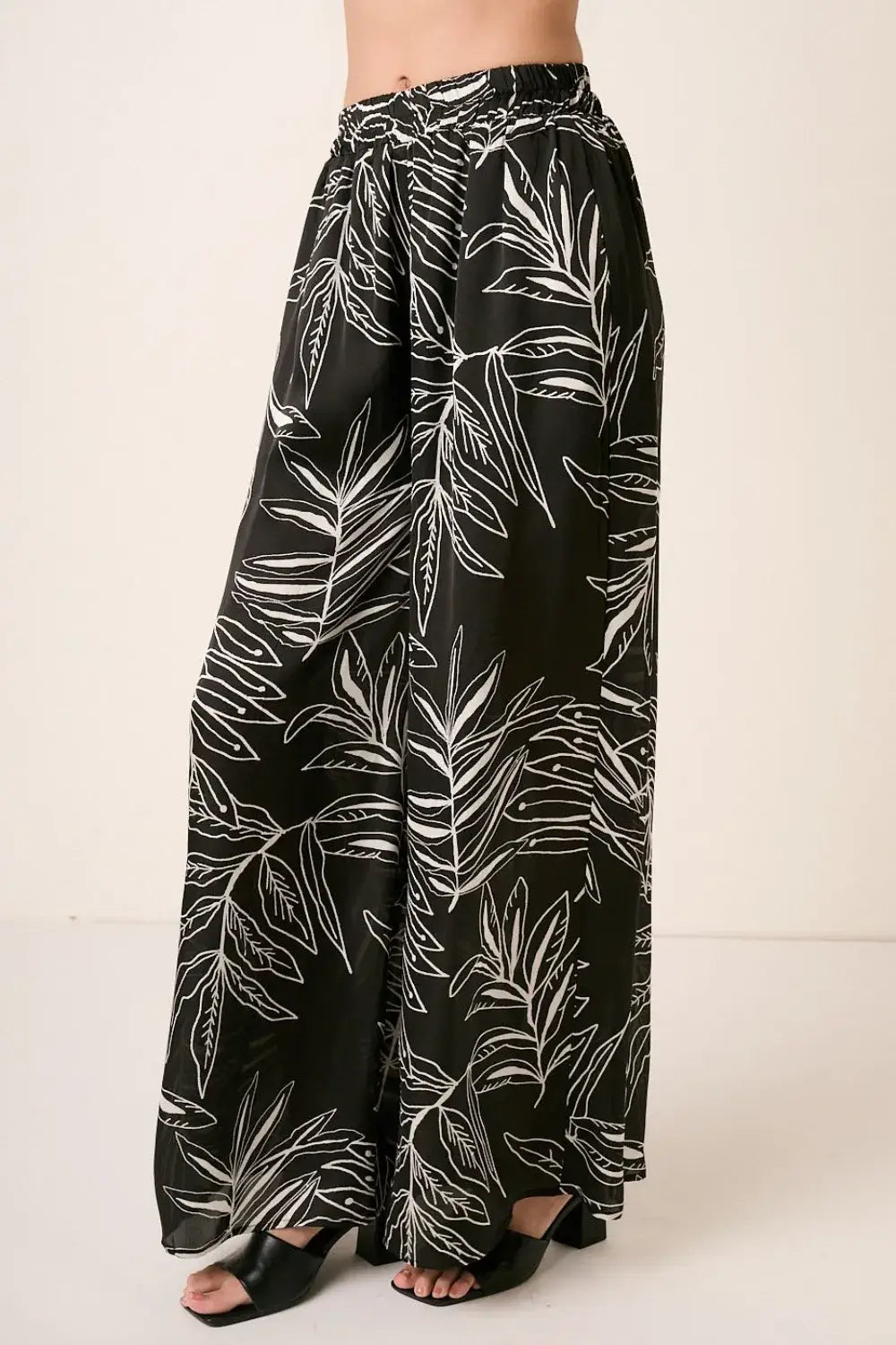 Black printed wide leg pants with tropical leaf design from Mittoshop