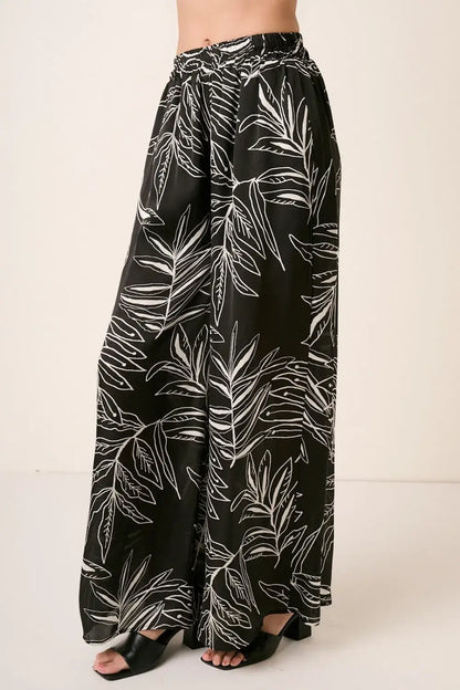 Black printed wide leg pants with tropical leaf design from Mittoshop