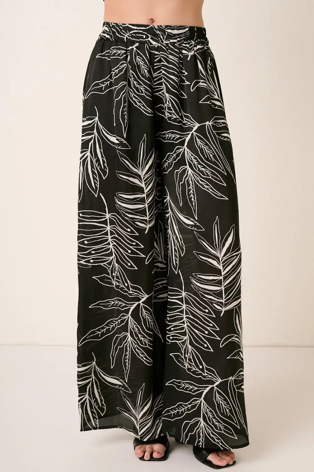 Black printed wide leg pants with tropical leaf design from Mittoshop
