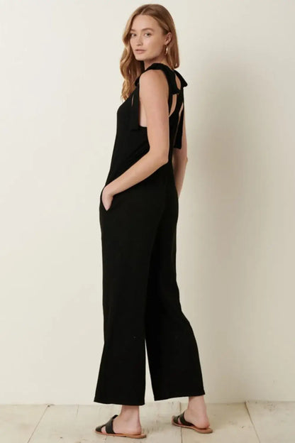 Black rib knit V-neck cross back jumpsuit with cut-out shoulders and wide-leg design