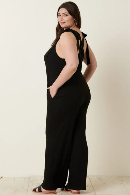 Black plus-size rib knit V-neck cross back jumpsuit with wide-leg design and thin straps