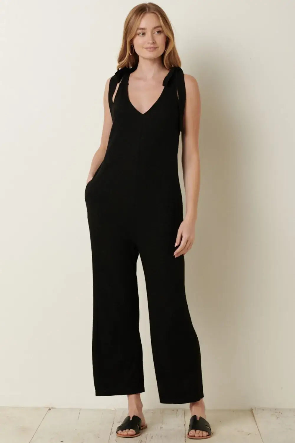Black rib knit V-neck cross back jumpsuit with wide-leg design and stretchy fabric