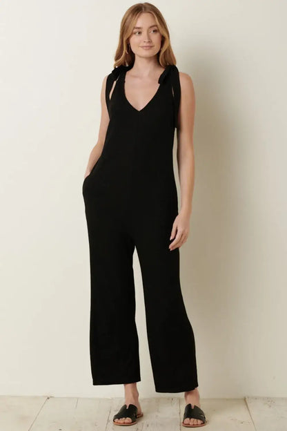 Black rib knit V-neck cross back jumpsuit with wide-leg design and stretchy fabric