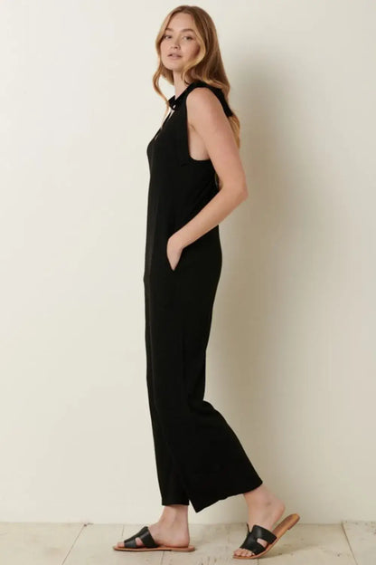 Black rib knit V-neck cross back jumpsuit with sleeveless design and flared legs