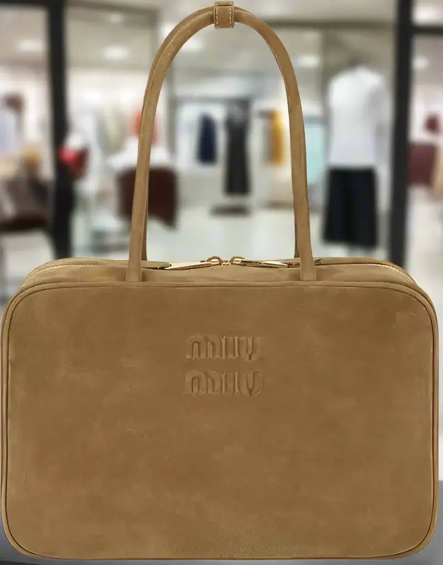 Miu Miu gold brown suede handbag with top handles and gold zipper for timeless luxury