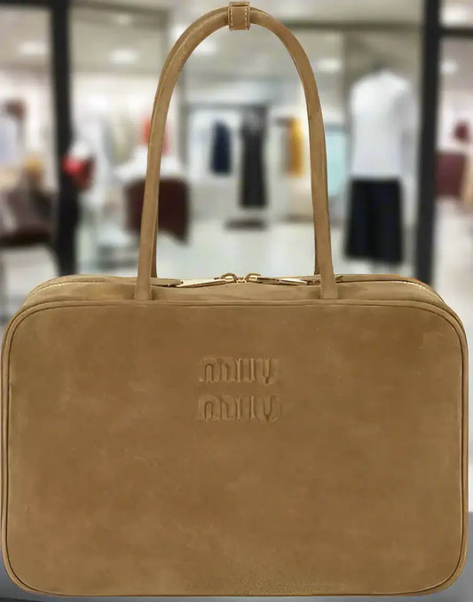 Miu Miu gold brown suede handbag with top handles and gold zipper for timeless luxury
