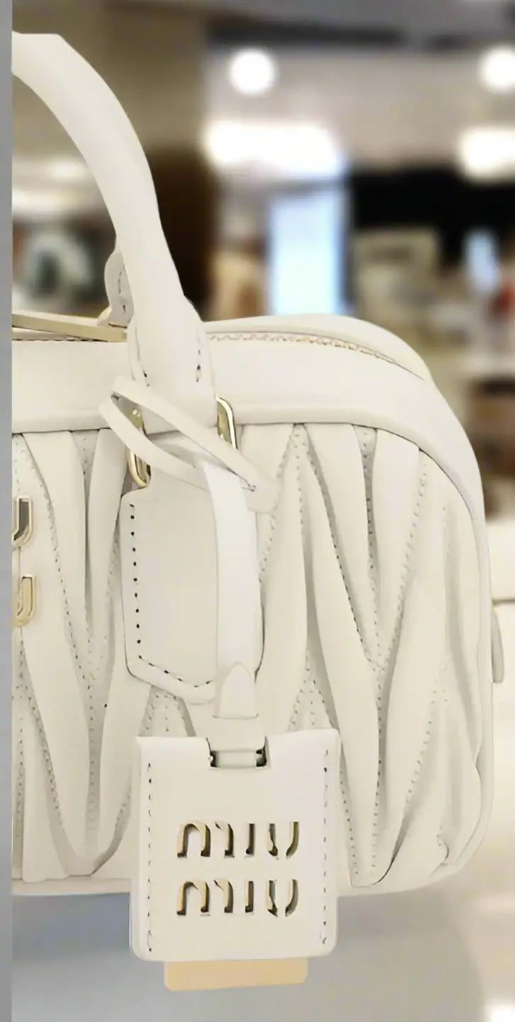 Miu Miu White Leather MATELASSÉ HANDBAG with pleated design and branded bag charm