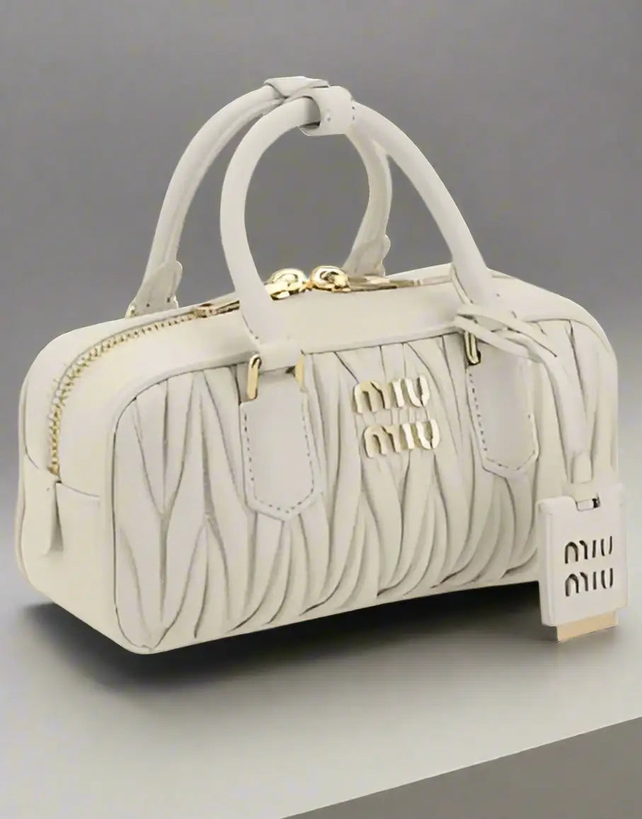 Miu Miu White Leather MATELASSÉ HANDBAG with gold hardware, stylish pleated top-handle satchel