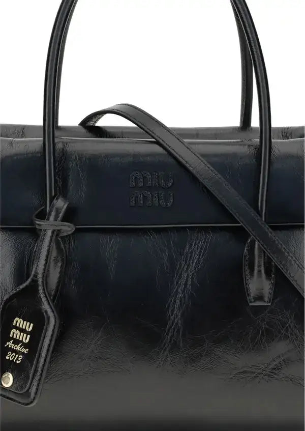 Miu Miu Womens Black Leather Solitaire Handbag with shoulder strap and luggage tag