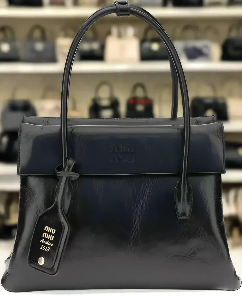 Dark blue glossy leather solitaire handbag with double handles and Miu Miu tag