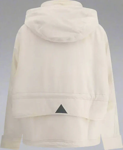 Cream-colored hooded parka nimba jacket with black triangular emblem on back hem