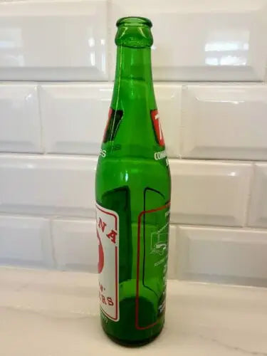 Green glass soda bottle from NCAA 1973 Indiana Hoosiers championship souvenir collection