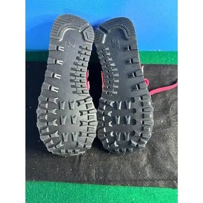 Black rubber outsoles of New Balance Red Low Top Sneakers with pink laces for women