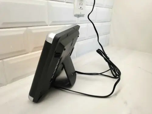Black digital alarm clock with silver trim on NFL Los Angeles Rams LED scoreboard stand