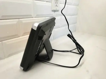 Black digital alarm clock with silver trim on NFL Los Angeles Rams LED scoreboard stand