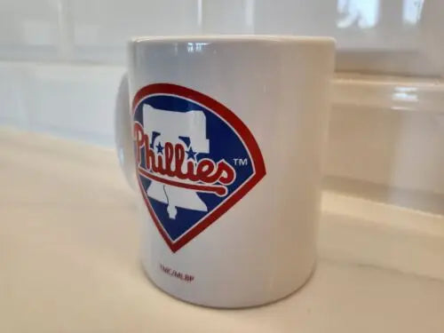 White Philadelphia Phillies ceramic coffee mug featuring the Phillies White Bell logo