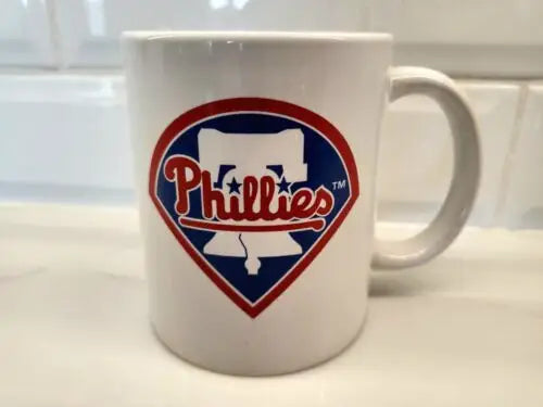 White Phillies ceramic coffee mug featuring the Philadelphia Phillies white bell logo