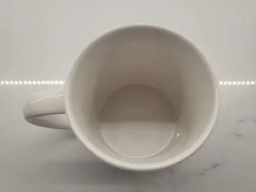Empty white ceramic coffee mug featuring Boise State Broncos logo design