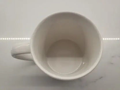 Empty white ceramic coffee mug featuring Boise State Broncos logo design