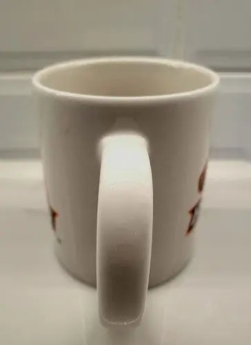White ceramic coffee mug featuring Boise State Broncos logo and handle