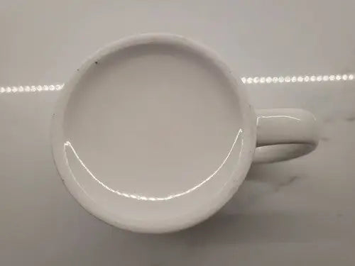 White ceramic coffee mug featuring Boise State Broncos logo for fans and collectors