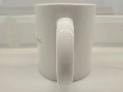 White ceramic coffee mug with handle featuring Brigham Young University logo