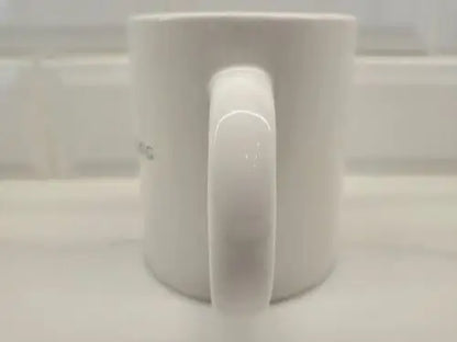 White ceramic coffee mug with handle featuring Brigham Young University logo