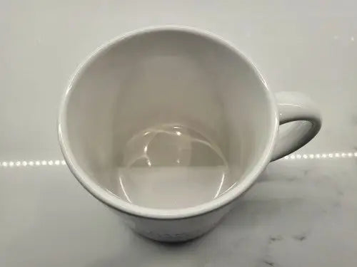 Empty white ceramic coffee mug featuring Brigham Young University branding