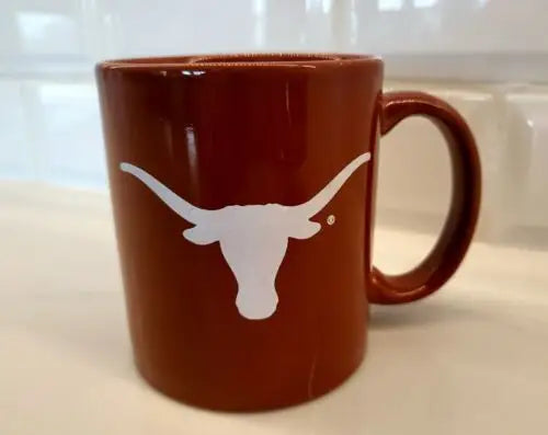 Burnt orange ceramic coffee mug with Longhorn logo for NCAA University of Texas fans