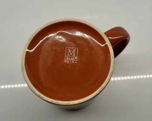 Brown ceramic coffee mug featuring University of Texas Longhorns logo perfect for coffee lovers