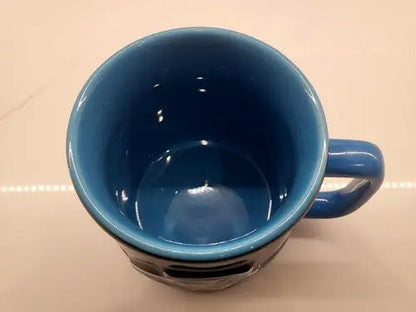 Blue ceramic mug featuring a Black 3D Sculpted Carolina Panthers logo design