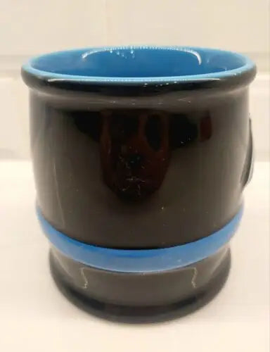 Black ceramic coffee mug with blue interior featuring Carolina Panthers 3D sculpted logo